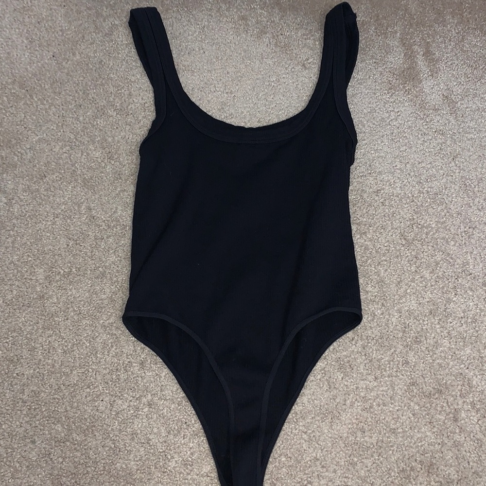 Brand new black ribbed and scoop neck bodysuit